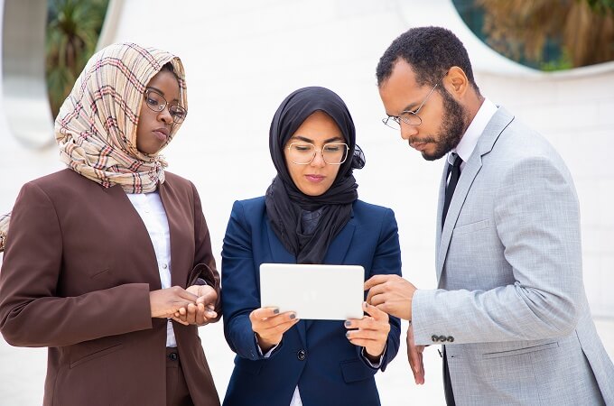 Business professionals reviewing content on tablet
